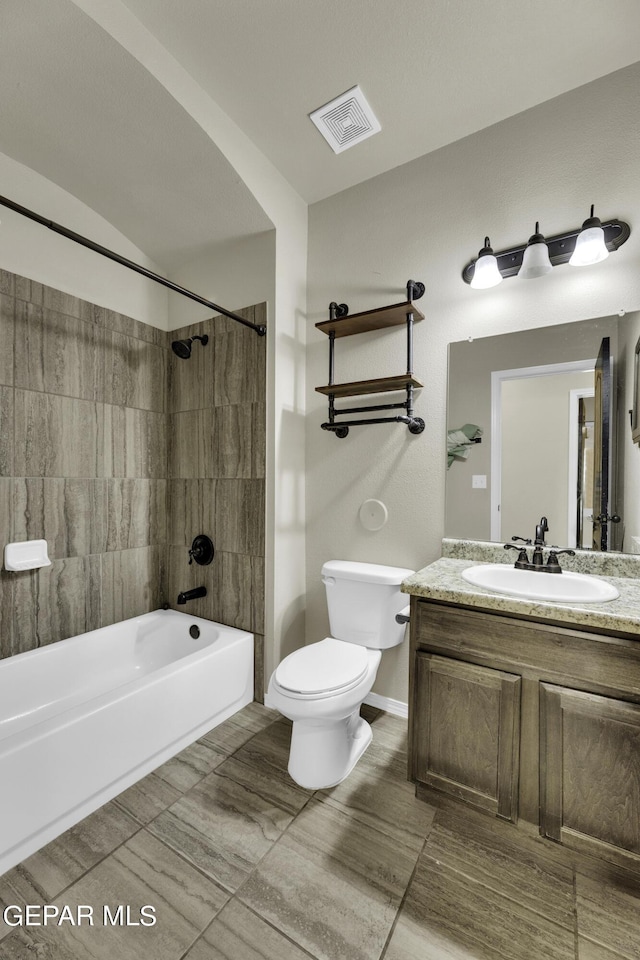 full bathroom with visible vents, tub / shower combination, baseboards, toilet, and vanity