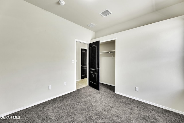 unfurnished bedroom with a closet, baseboards, visible vents, and carpet flooring