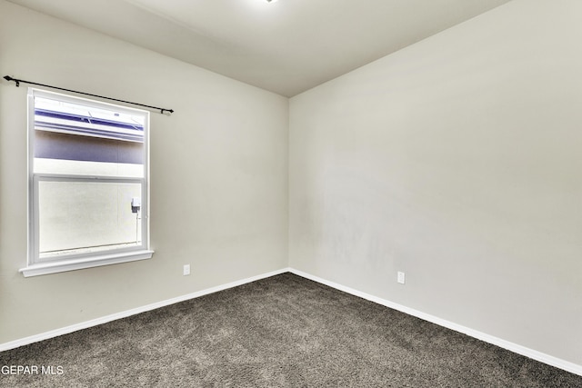 unfurnished room with baseboards and carpet floors