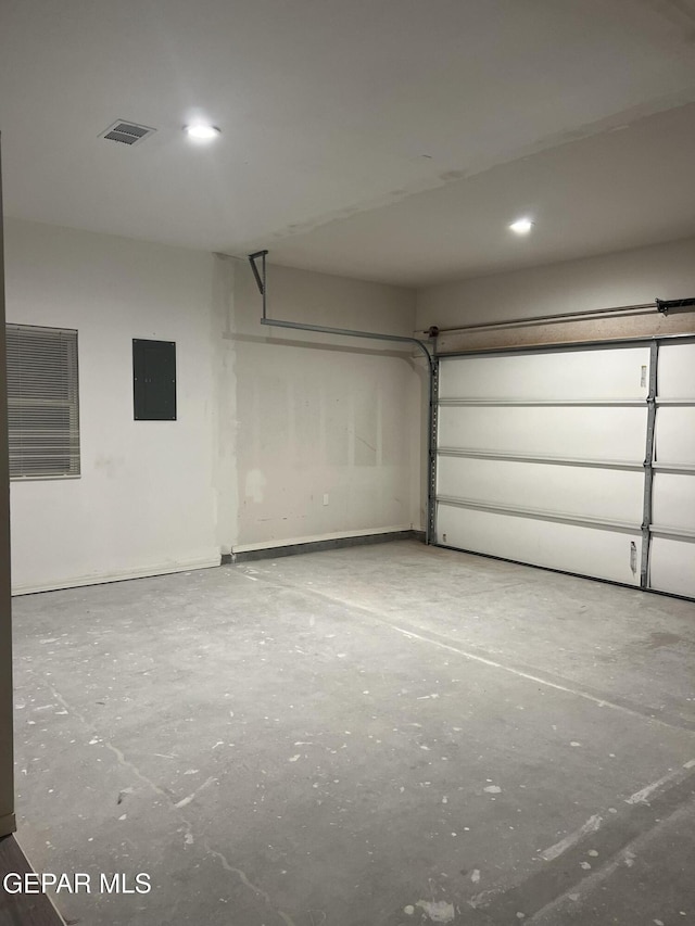 garage featuring electric panel and visible vents