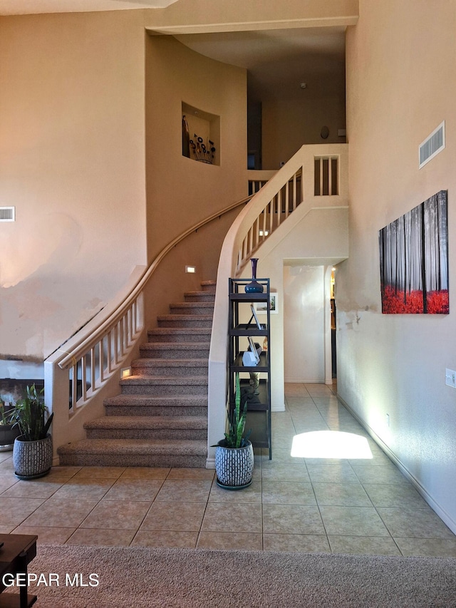 staircase with tile patterned floors