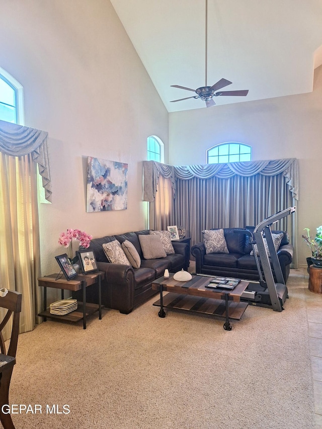 living room featuring carpet floors, high vaulted ceiling, and ceiling fan