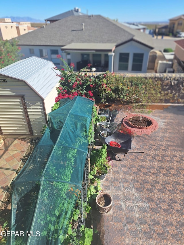 exterior space featuring a shed and an outdoor fire pit