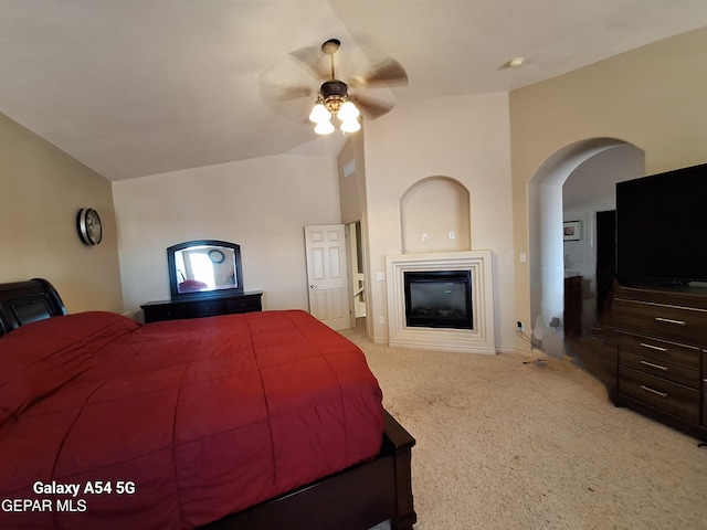 carpeted bedroom with ceiling fan and lofted ceiling