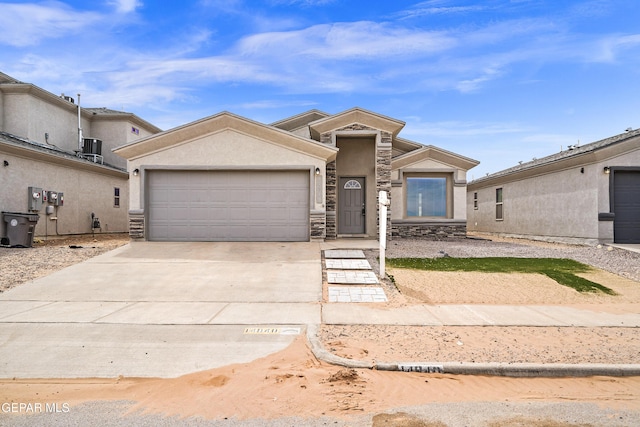 view of front of property with concrete driveway, stucco siding, central AC unit, stone siding, and an attached garage