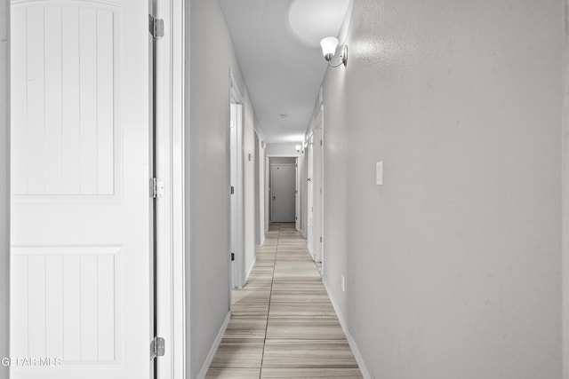 hall featuring baseboards