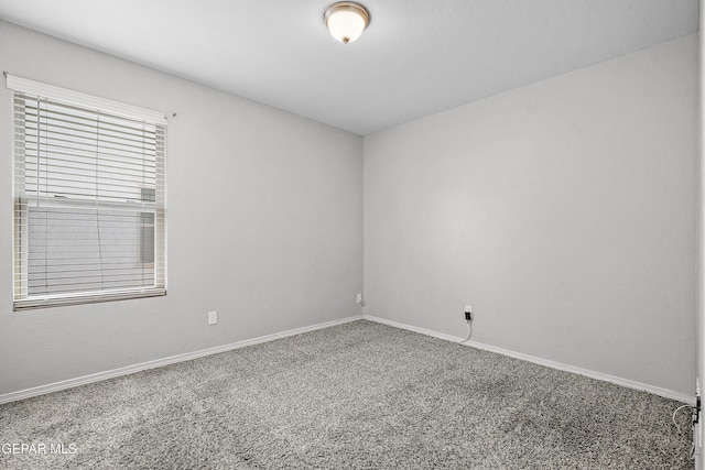 carpeted spare room with baseboards