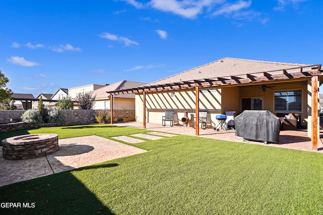 view of yard with ceiling fan, a patio area, a fire pit, and a pergola