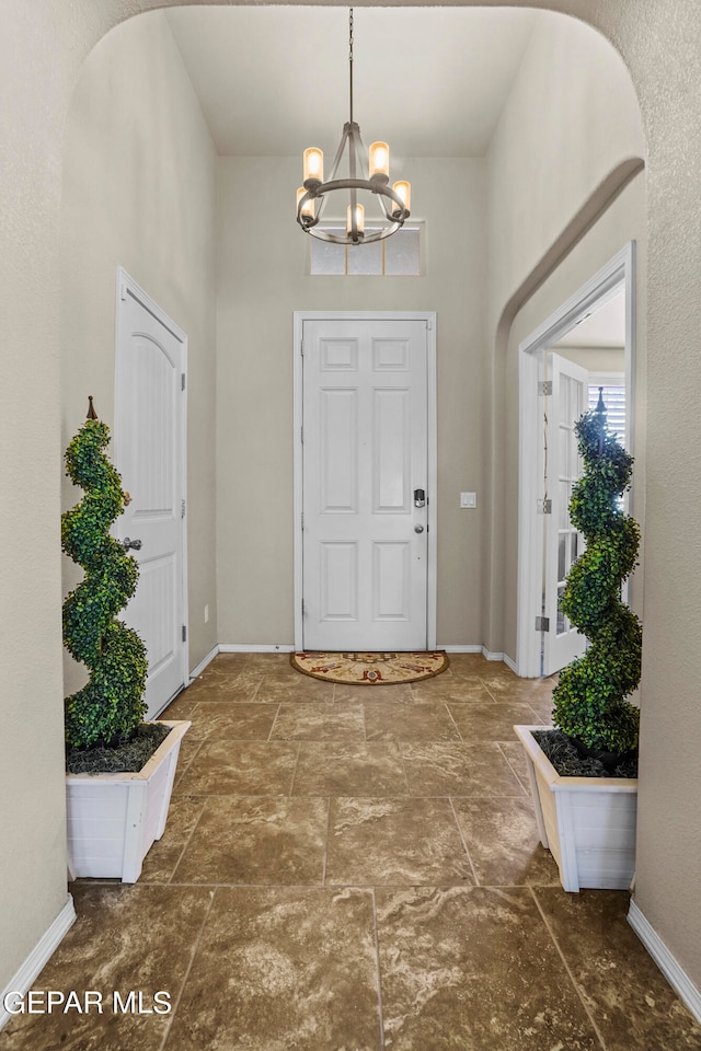 foyer featuring a chandelier