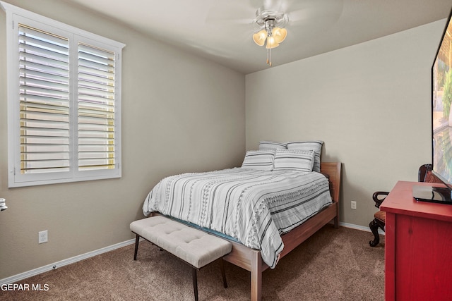 bedroom with dark colored carpet and ceiling fan