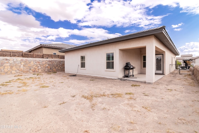 rear view of house featuring a patio