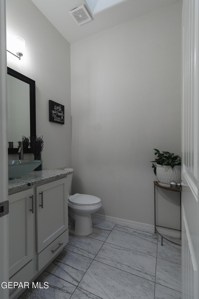 bathroom with vanity and toilet