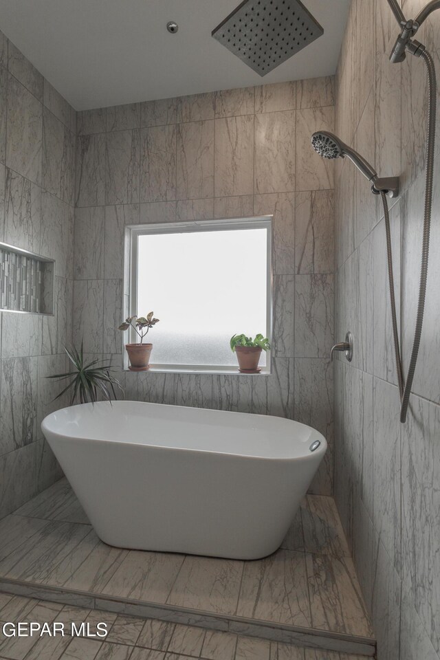 bathroom featuring tile walls and shower with separate bathtub