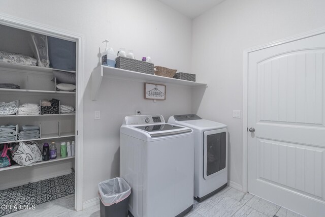 laundry room featuring washing machine and clothes dryer