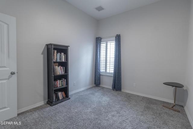 carpeted spare room with visible vents and baseboards