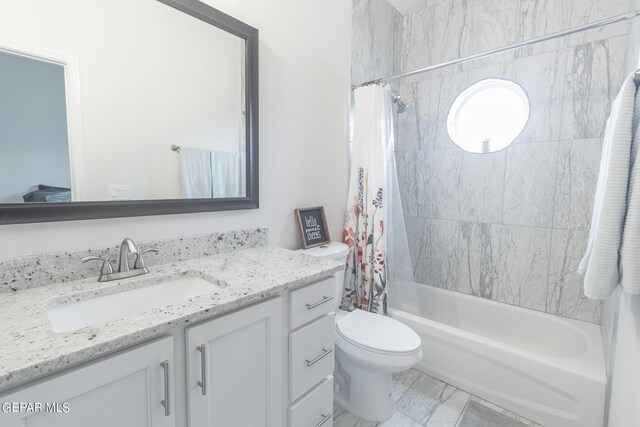 full bathroom featuring vanity, toilet, and shower / tub combo with curtain