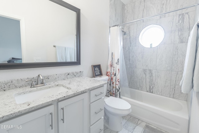 bathroom featuring marble finish floor, vanity, toilet, and shower / bath combo with shower curtain