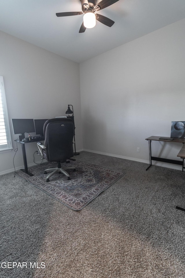 home office featuring carpet flooring, a ceiling fan, and baseboards