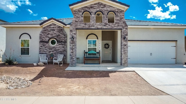 french provincial home with a tile roof, stucco siding, an attached garage, and concrete driveway