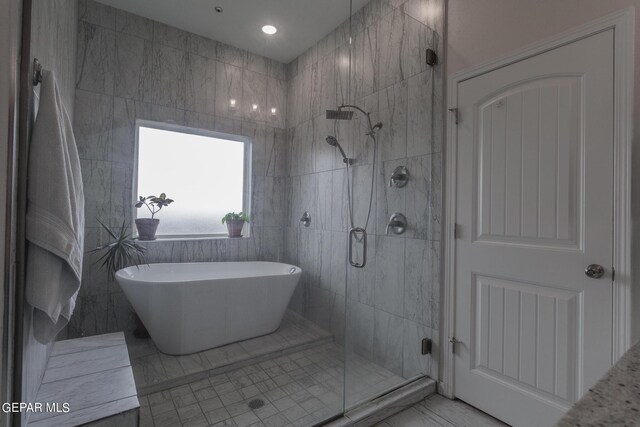 bathroom featuring tile walls, plus walk in shower, and tile patterned floors