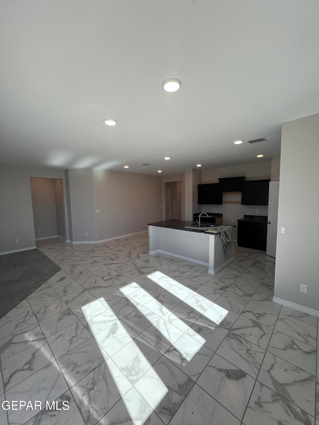 unfurnished living room featuring sink