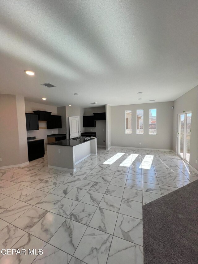 unfurnished living room featuring a textured ceiling