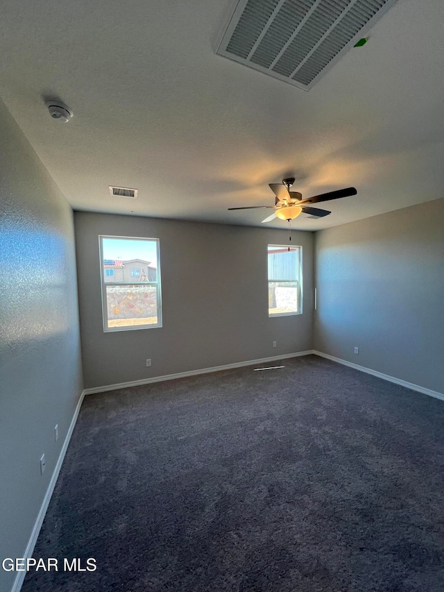 carpeted spare room with ceiling fan