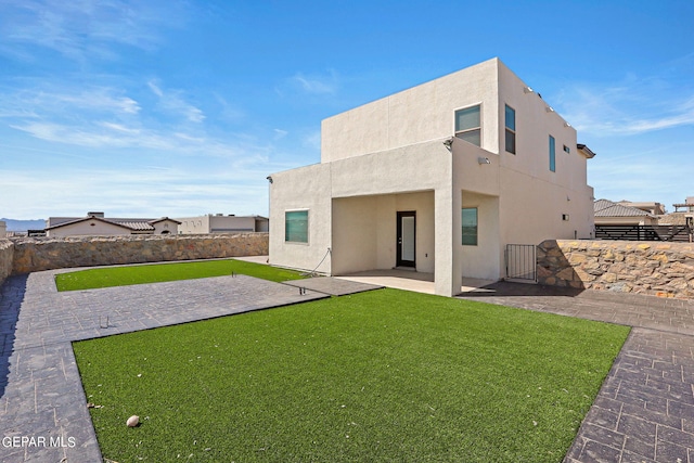 rear view of property with a patio area and a yard