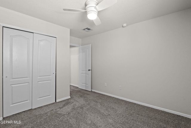 unfurnished bedroom with carpet, ceiling fan, and a closet