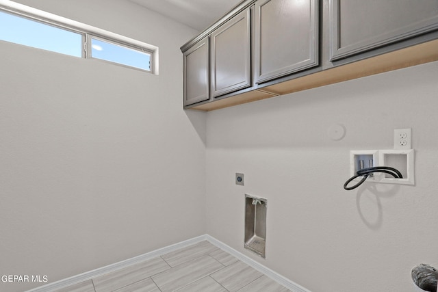 washroom with hookup for a washing machine, cabinets, hookup for a gas dryer, and hookup for an electric dryer