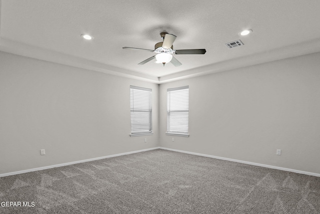 unfurnished room with ceiling fan, carpet, and a textured ceiling