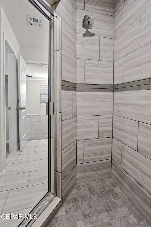 bathroom with a tile shower