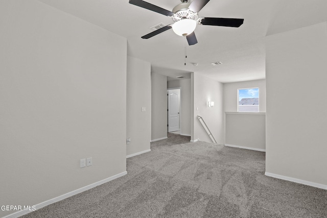 carpeted spare room with ceiling fan