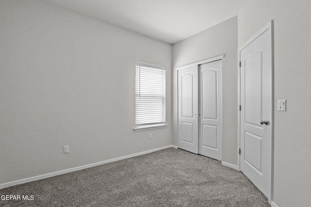 unfurnished bedroom with carpet flooring and a closet