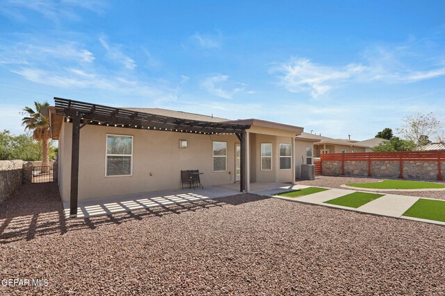 rear view of house with a pergola and a patio