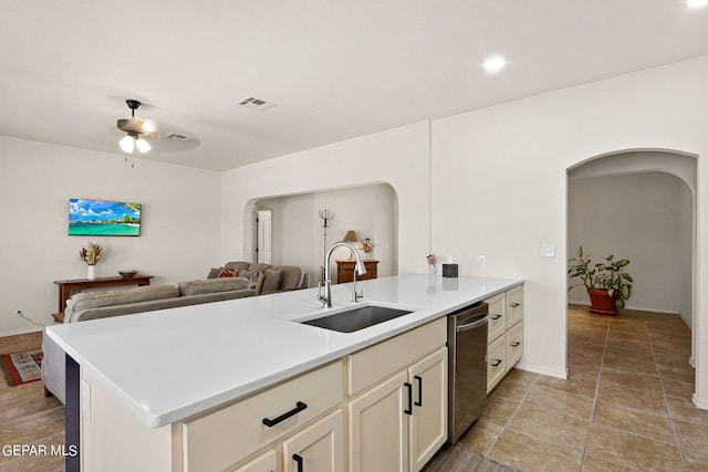 kitchen featuring stainless steel dishwasher, ceiling fan, sink, and kitchen peninsula