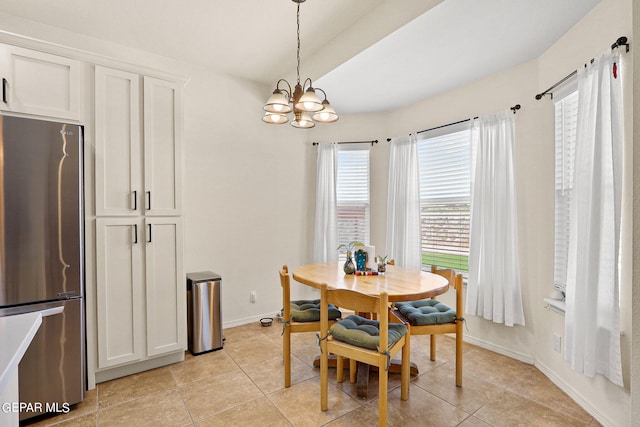 dining room with light tile patterned floors and an inviting chandelier