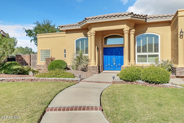 doorway to property with a lawn