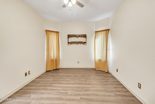 unfurnished room with light wood-type flooring and ceiling fan