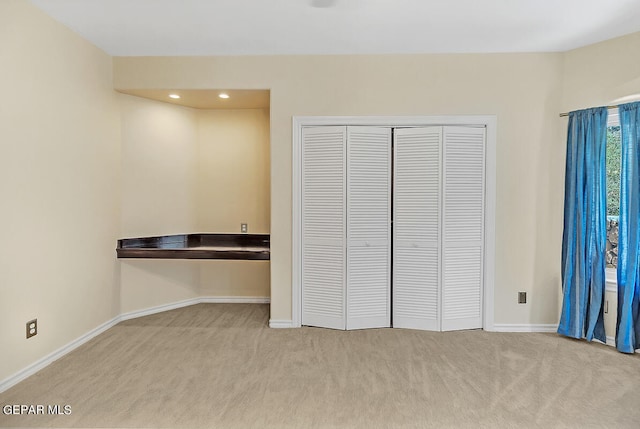 unfurnished bedroom with light carpet