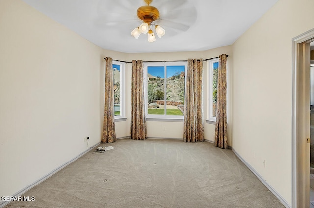 unfurnished room featuring ceiling fan and light carpet