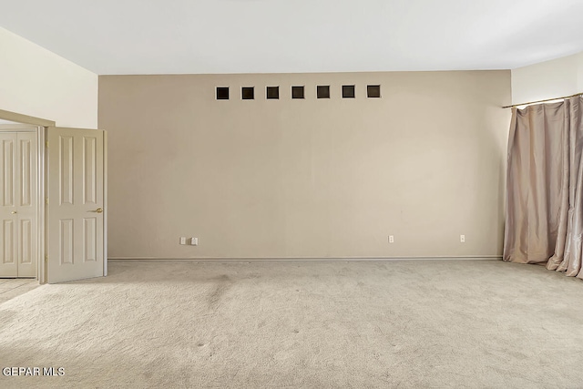 unfurnished room with light colored carpet