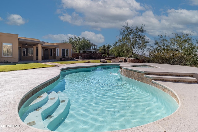 view of pool featuring a yard and a hot tub