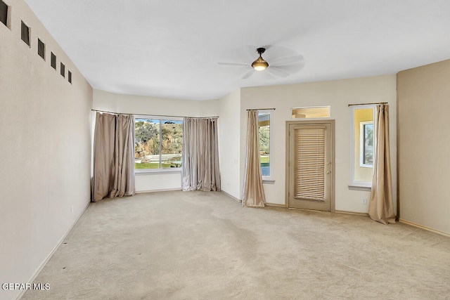 empty room with ceiling fan and light colored carpet