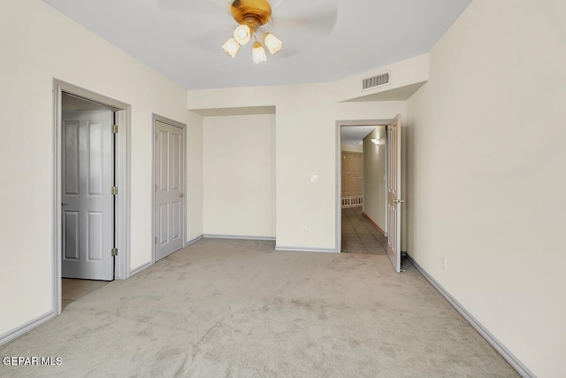 unfurnished bedroom with light carpet and ceiling fan