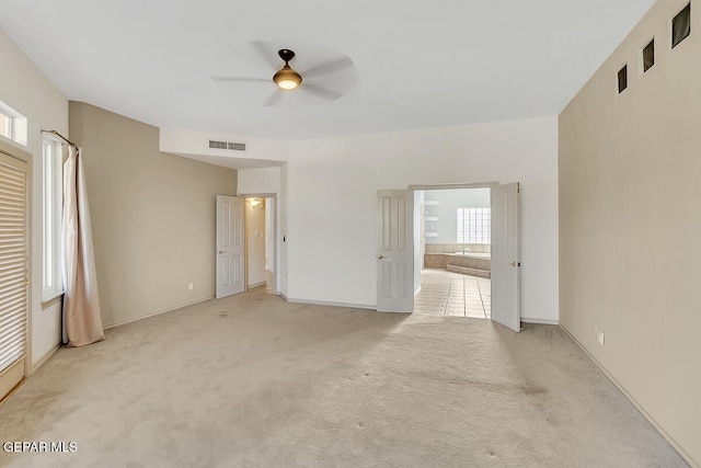 unfurnished room with light carpet and ceiling fan