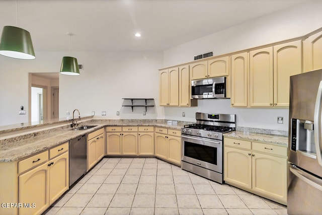 kitchen with pendant lighting, light tile patterned flooring, sink, appliances with stainless steel finishes, and light stone countertops