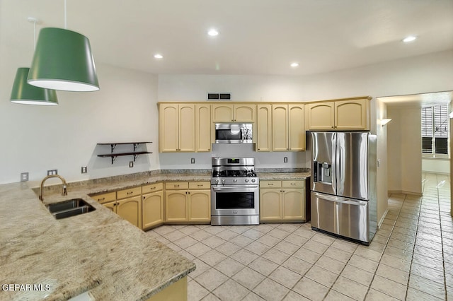 kitchen featuring light stone counters, stainless steel appliances, sink, light brown cabinetry, and light tile patterned floors