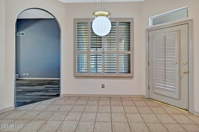 unfurnished dining area featuring light wood-type flooring