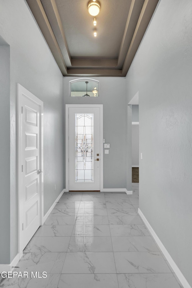 doorway featuring a tray ceiling